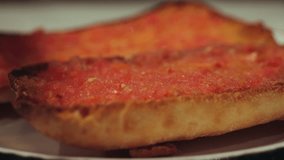 Delicious Catalan Tomato Bread tapas with crushed tomatoes with olive oil close-up. Pan con tomate. High quality 4k footage - Powered by Shutterstock - Get 15% off with code: PIKWIZARD15