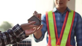 Engineer and manager discussing blueprint outdoors; wearing helmets, planning property development project with laptop and tablet, teamwork, strategy, innovation, safety, construction, real estate, pr - Powered by Shutterstock - Get 15% off with code: PIKWIZARD15