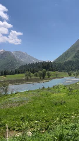 Vertical video of the Indus River flowing with crystal-clear blue water along the Astore–Skardu road. Fed by Himalayan snow, surrounded by rugged mountains and untouched natural beauty.
