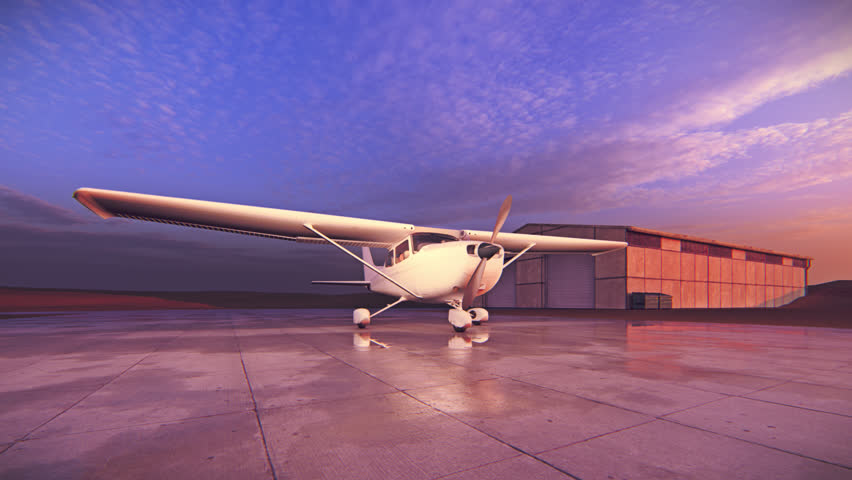 A light aircraft, Cessna, waits on the runway at a small airport