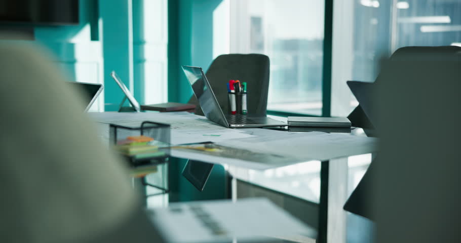 Vacant, boardroom and paperwork on desk, tech and financial report for meeting or corporate company. Empty, chairs and workplace with laptop for training session, documents and data on table in room