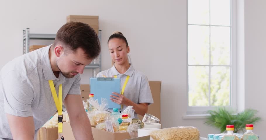 Food bank box giving help to old retired senior man, young girl, volunteer group working in charitable meal foundation making donation. Charity separating basic need provisions, free meal for people 
