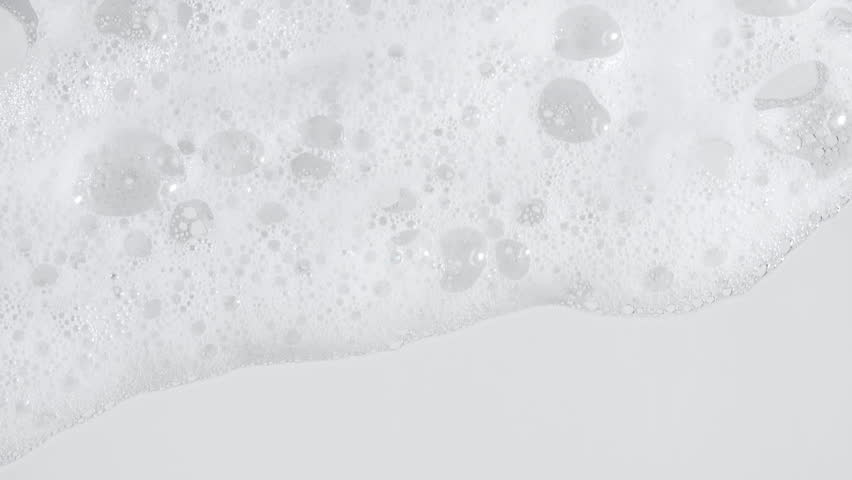 Texture of white soap foam with bubbles abstract background. Soap sud macro structure. Bathtup Soap Foam. Natural White Shampoo Bubbles Motion.