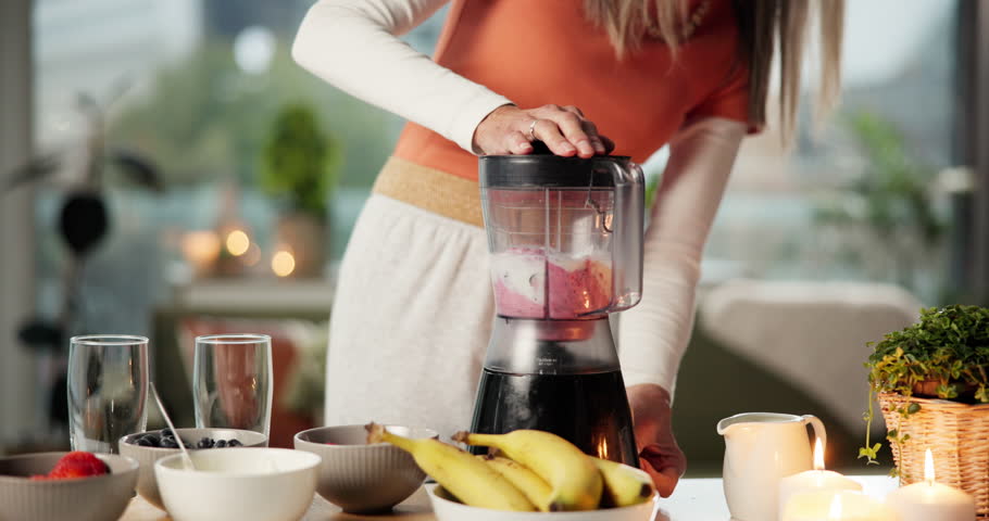 Blender, smoothie and woman in kitchen for health, diet and detox with vitamins, minerals and benefits. Home, wellness and person with drink, fruit shake and juice for protein, nutrition or digestion