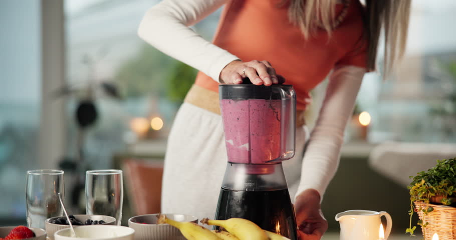 Blender, smoothie and woman in kitchen for health, diet and detox with vitamins, minerals and benefits. Home, wellness and person with drink, fruit shake and juice for protein, nutrition or digestion