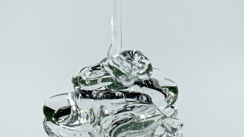 Closeup Shot of Clear Cosmetic Gel Fluid, Essential Oil With Molecule Bubbles Flowing on White Background. Macro Shot of Organic Products, Medicine. Dermatology Science Laboratory. 