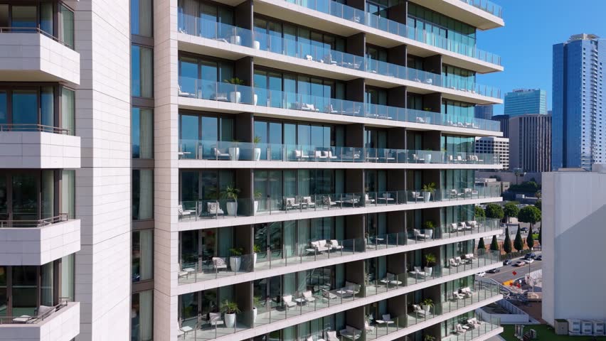 Modern glass high-rise with luxury lounge balconies in Los Angeles