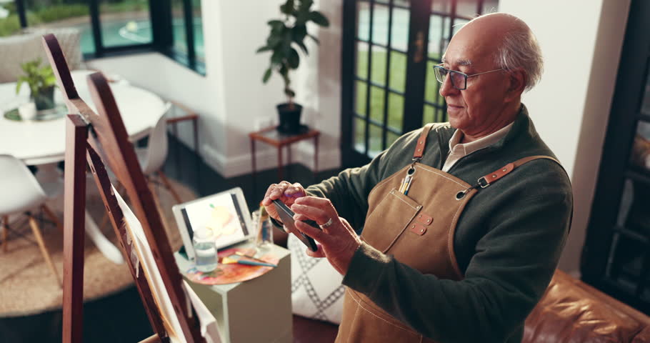 Senior man, artist or picture with phone on canvas in home for art, hobby or fun activity. Elderly, male person or painter with mobile smartphone on easel for photography, pride or artwork in house