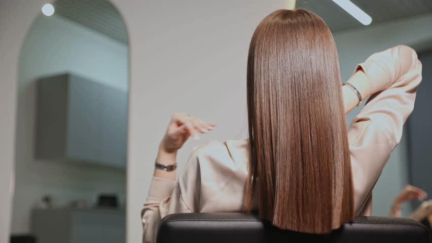 Woman after keratin haircare procedure. Healthy hair care treatment in salon.