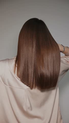 Woman after treatment haircare procedure. Healthy hair care keratin in salon.