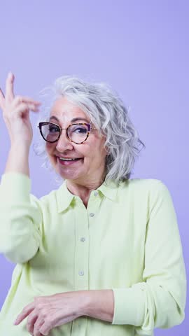 Joyful senior woman dancing and expressing happiness