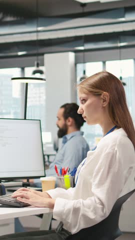 Vertical video Junior developer optimizing performance using AI LLM chatbot recommendations. Young woman uses artificial intelligence assistant to convert manual workflows into automated scripts