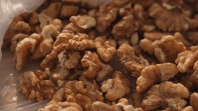 Close-up dolly shot of raw walnut halves on a kitchen surface - Powered by Shutterstock - Get 15% off with code: PIKWIZARD15