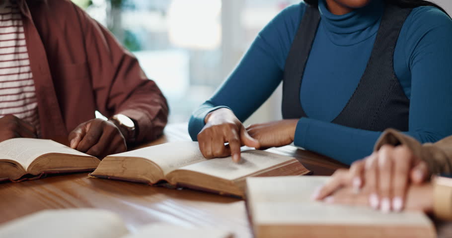 Prayer, group and hands with scripture, bible study or explanation of verse for religion or worship. Reading, literature or people with book for guidance, together or Christian with gospel for belief