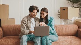 Couple exploring new home options while settling into their apartment - Powered by Shutterstock - Get 15% off with code: PIKWIZARD15