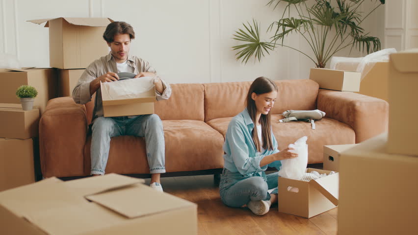Family relocates to new apartment while unpacking boxes together