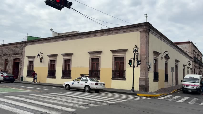 Morelia, Mexico – 04.21.2025: Street scenes in central Morelia during a public event with closed roads, cyclists, market tents, and views of colonial architecture and museum interiors