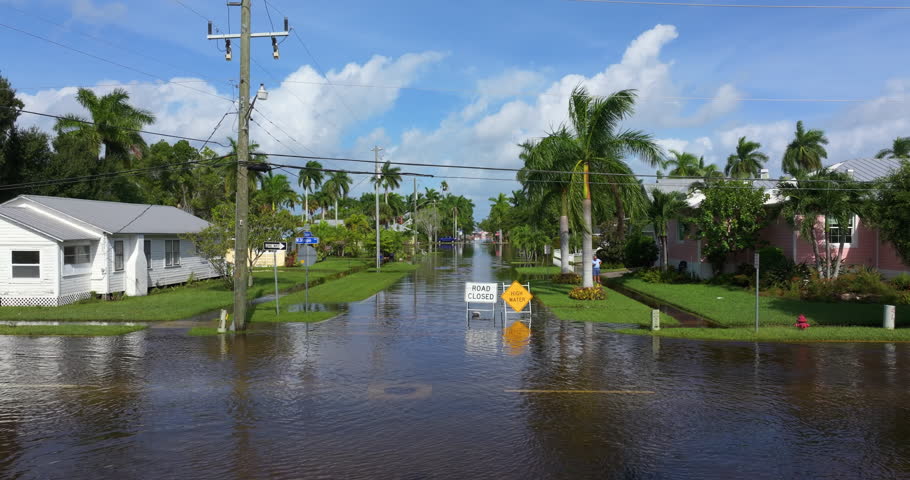 Road closed because of flooding danger with warning signs blocking driving of cars. Hurricane Milton aftermath in Punta Gorda, Florida.