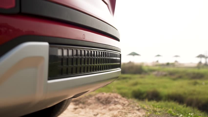 Cinematic shot of bumper grill of car.	