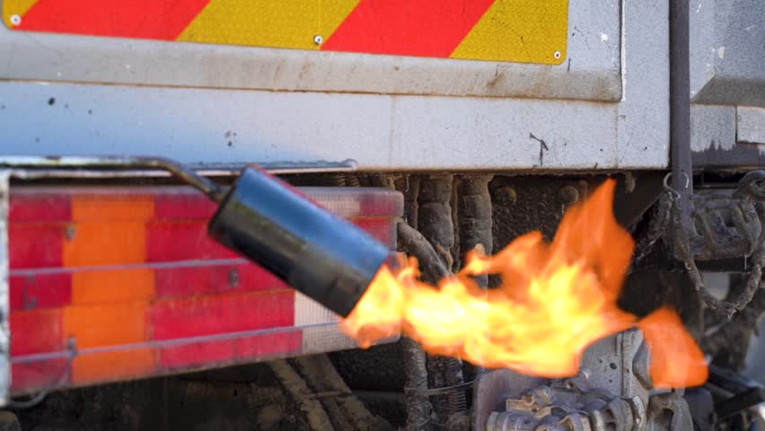 Truck Used for Coating Asphalt with Hot Liquid Bitumen with Handheld Torch on Construction Site