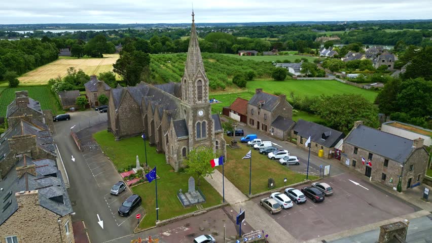 Smooth backward drone movement from the Church of Notre-Dame-du-Guildo in Saint-Cast-le-Guildo, Côtes-d
