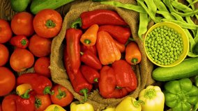 Top view of assorted fresh vegetables including red and yellow bell peppers, tomatoes, green beans, and peas. Colorful organic produce arranged in a rustic style on a natural background. - Powered by Shutterstock - Get 15% off with code: PIKWIZARD15