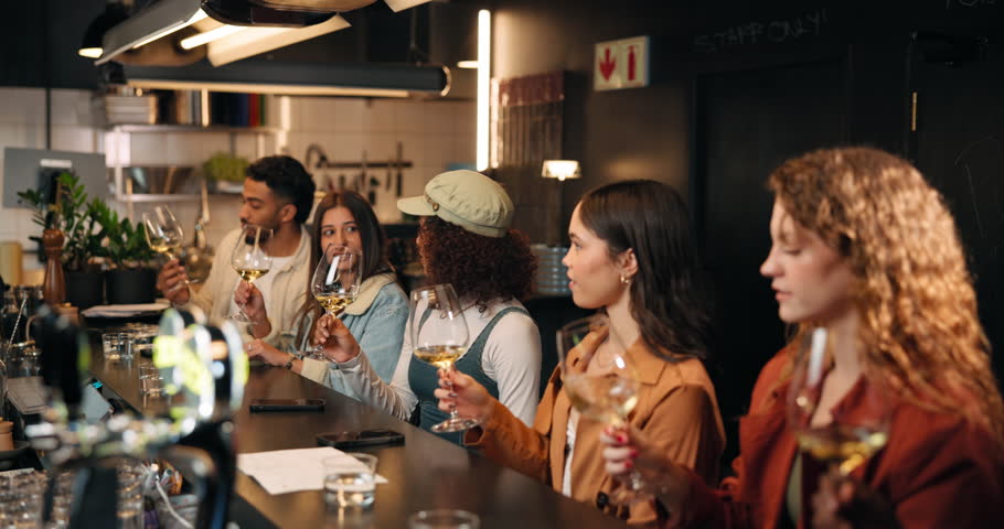 People, drinking and wine in glass at bar for taste testing, quality control and experience. Row, customer and alcohol beverage for happy hour, prepare palate and hospitality industry at brewery pub