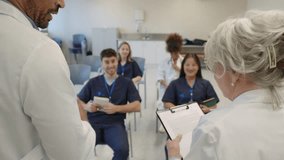Medical students raising hands during hospital lecture in slow motion - Powered by Shutterstock - Get 15% off with code: PIKWIZARD15