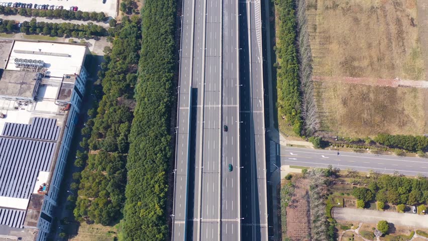 Witness the intricate transportation systems of Wuhan City as aerial views highlight major highways and surrounding landscapes during a clear day. The urban development is impressive.