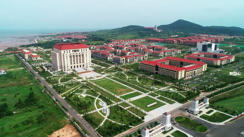 Explore the stunning aerial perspective of Shandong University in Qingdao, highlighting its unique architecture, spacious green areas, and coastal proximity.