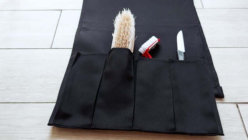 A compact toolkit folds open: brushes, scissors, and knife nestled inside a sleek travel case-neatly arranged, tactile, ready for any creative moment
