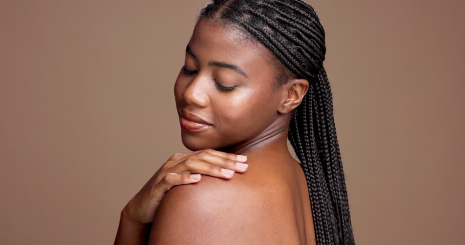 Shoulder, body care and smile with face of black woman in studio for skincare, beauty and hygiene. Glow, dermatology and shine with female model on brown background for mockup space and grooming