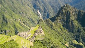 Drone orbits above Machu Picchu with sunlight cutting through misty mountain air at dawn, establishing - Powered by Shutterstock - Get 15% off with code: PIKWIZARD15