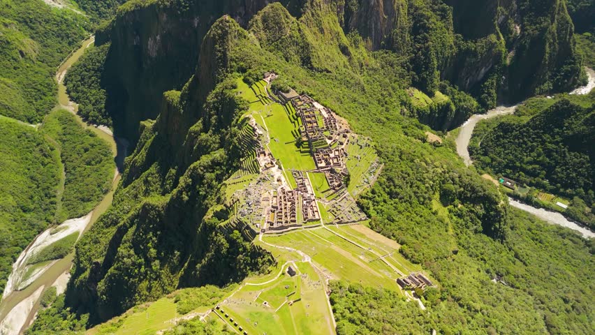 Establishing drone of Incan ruins and dense green mountains near Machu Picchu in Peru