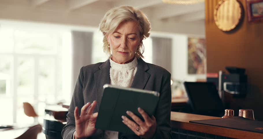 Hotel, tablet and business mature woman for online booking, accommodation and digital check in. Work trip, hospitality and happy person on tech for reservation on website, internet and networking