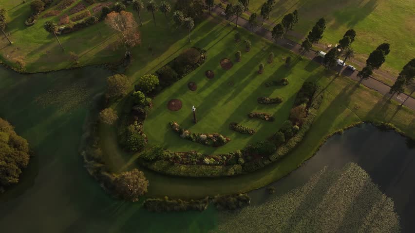 Drone over a circular garden formation surrounded by greenery in Centennial Park, Sydney NSW Australia