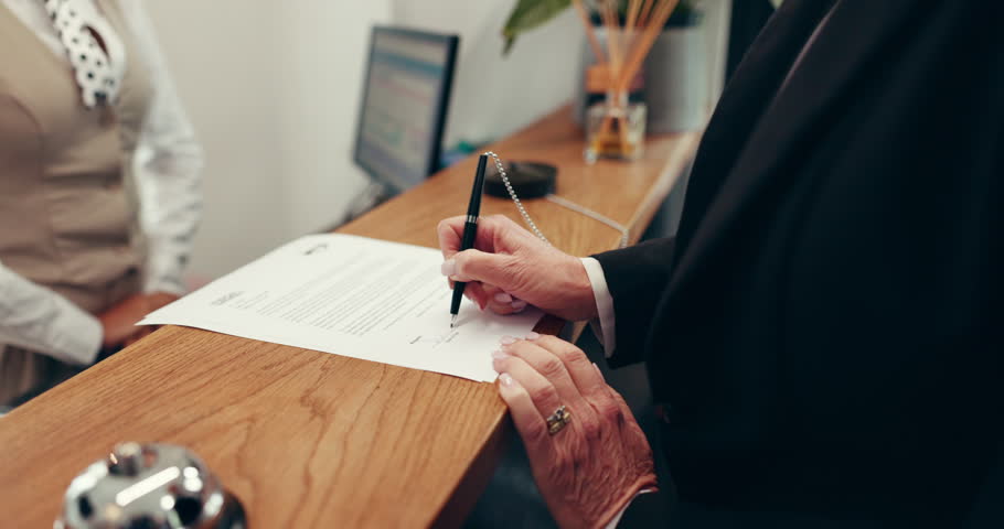 Hands, woman and signature at reception in hotel for check in, registration or hospitality service. Pen, paper and sign with client at motel for reservation confirmation, travel or accommodation form