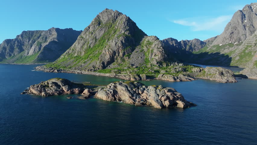 Scenic aerial perspective of Lofoten Islands, Norway, capturing majestic mountains, serene waters, and rugged coastline