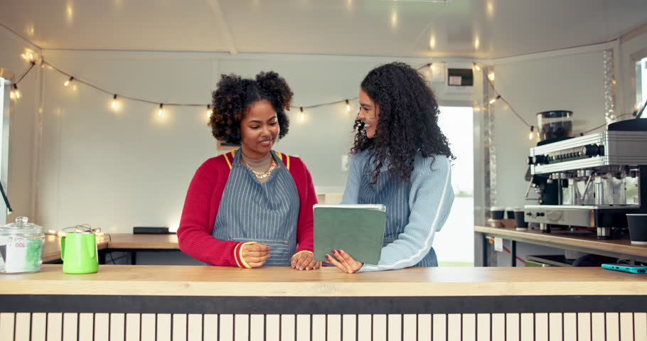 Women, barista and tablet with high five for celebration, social media and food truck cafe teamwork. People, tech and waiter for customer service, partnership or mobile coffee shop review for success