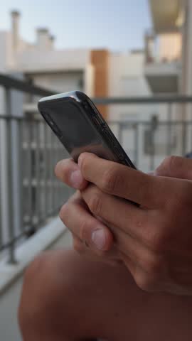 Typing message on smartphone – vertical hands close-up. Close-up vertical shot of fingers typing a text message on mobile phone touchscreen. Communication, chat, texting in portrait 9:16 video format.