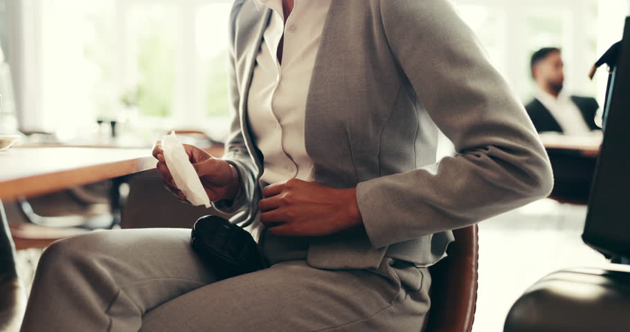 Sanitary pad, pain and hands of woman in lobby with period ache, menstruation and PMS on travel. Consultant, business person and work trip with feminine hygiene, monthly cycle or stomach cramps