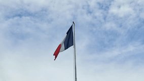 The French Flag on blue cloudy sky. - Powered by Shutterstock - Get 15% off with code: PIKWIZARD15