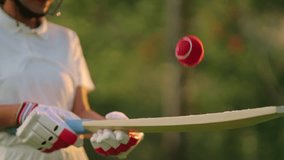 unknown athlete sports woman hold bat playing with red ball outdoor ground. unrecognizable female cricket player wear white uniform protective helmet and hand gloves standing at match playground - Powered by Shutterstock - Get 15% off with code: PIKWIZARD15