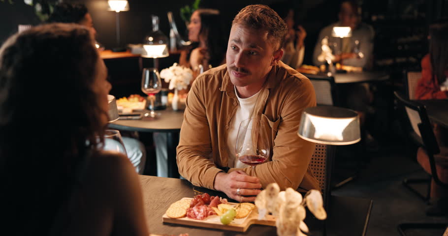 Conversation, date and romance with couple in restaurant at night for bonding or celebration. Fine dining, love and smile with people at table together for anniversary, cuisine or relationship chat