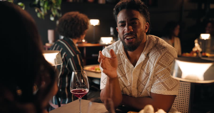 Conversation, wine and couple on date in restaurant for love, bonding or anniversary celebration. Talking, fine dining and man with woman for alcohol drink at romantic dinner together at diner.