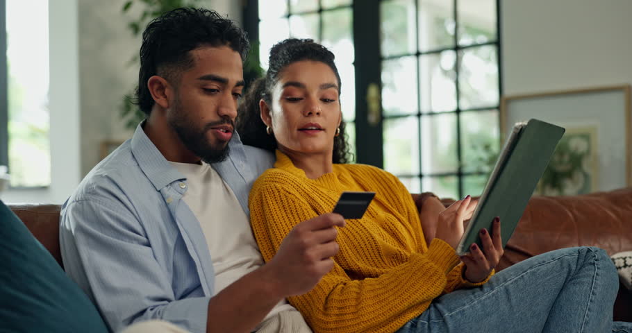 Couple, tablet and credit card on sofa with online shopping, laugh and easy payment in lounge at house. People, happy man and woman with fintech app, ecommerce or discount sale on couch at apartment