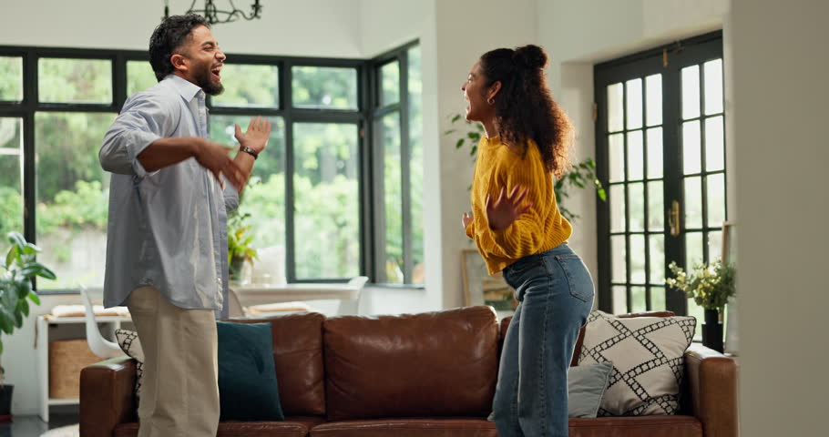 Smile, dancing and couple in home with music, fun or bonding together in living room with energy. Happy, love and man with woman for moving to playlist, album or radio for entertainment in apartment.