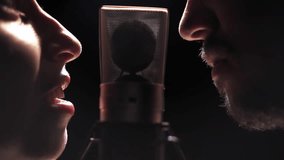 Man and woman singing for each other face to face on microphone - Powered by Shutterstock - Get 15% off with code: PIKWIZARD15