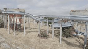 drone flying over an abandoned rusty water park with broken slides - Powered by Shutterstock - Get 15% off with code: PIKWIZARD15
