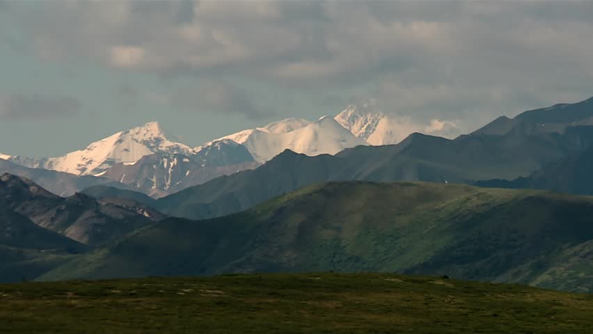 Sunlit snowy mountains of Denali national park range in Alaska, North America